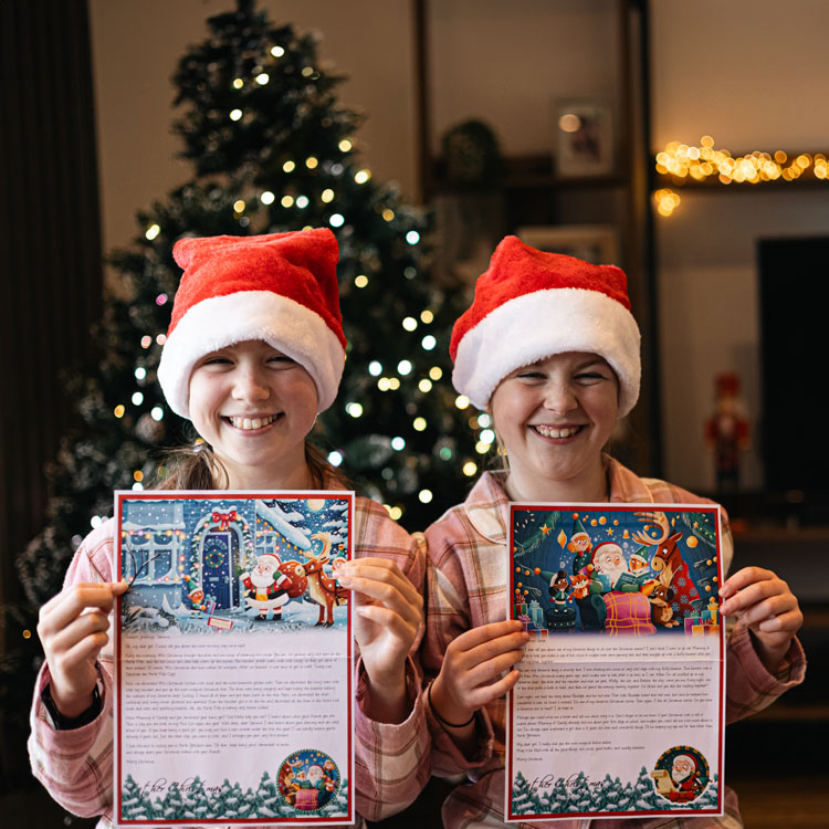 two children holding their letters from Santa